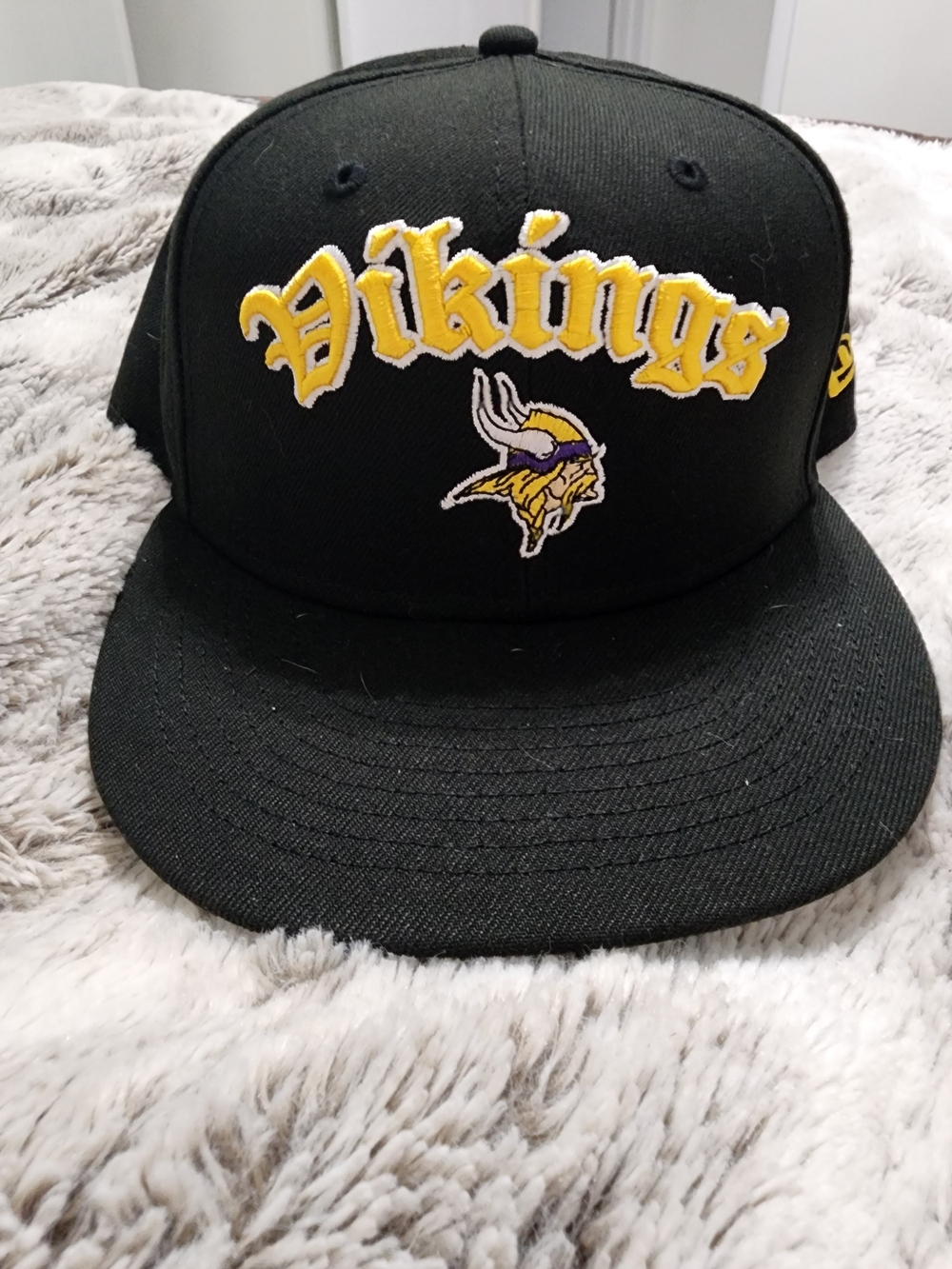 New Era Black Vikings Snapback Hat with Yellow and Purple Logo